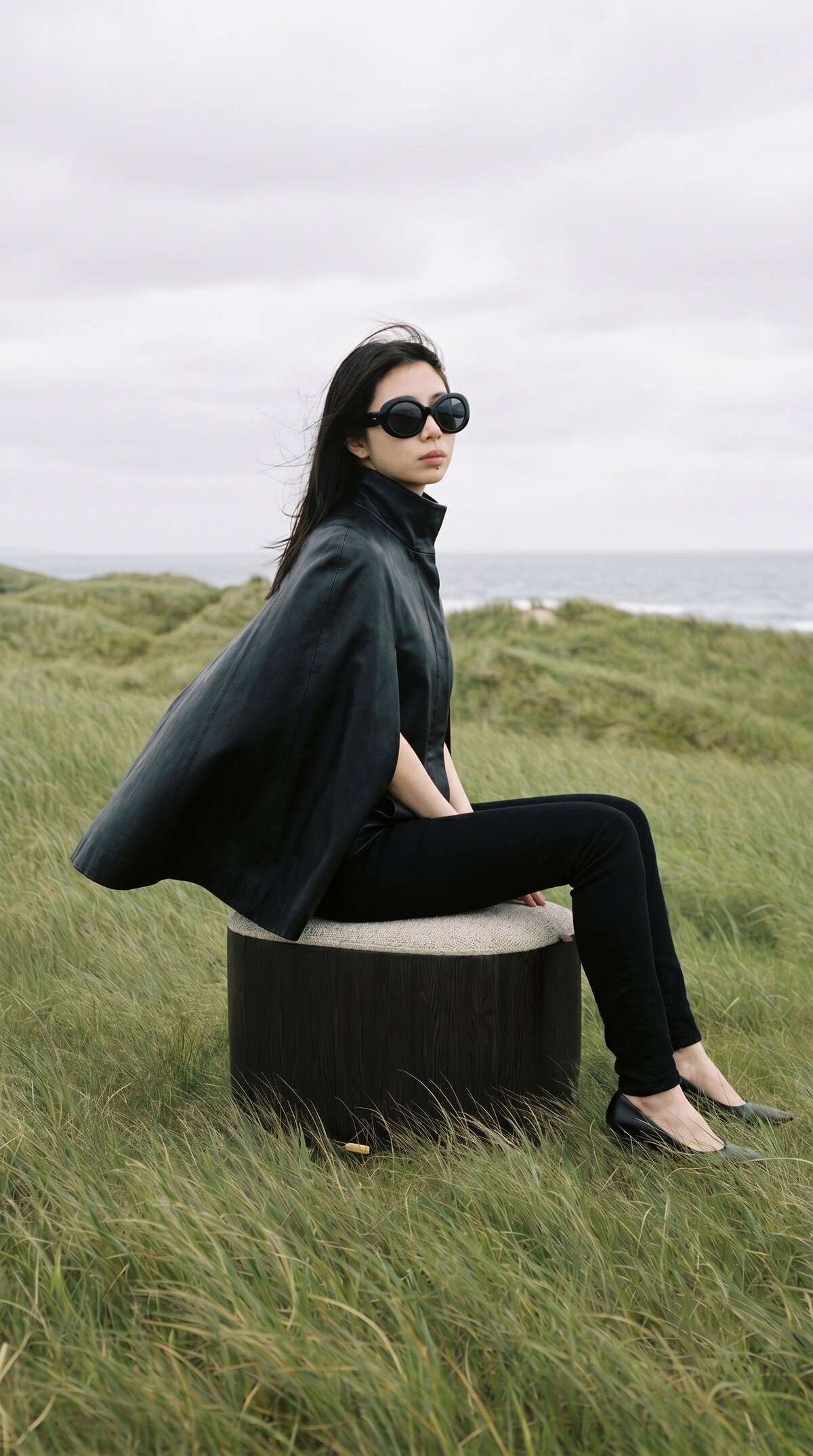 Ishi stool — figure in cape on dunes