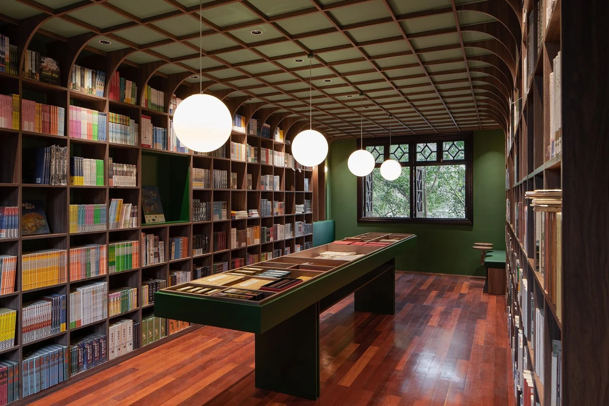 Reading rooms with timber line ceilings, jade-green panels and a long display table