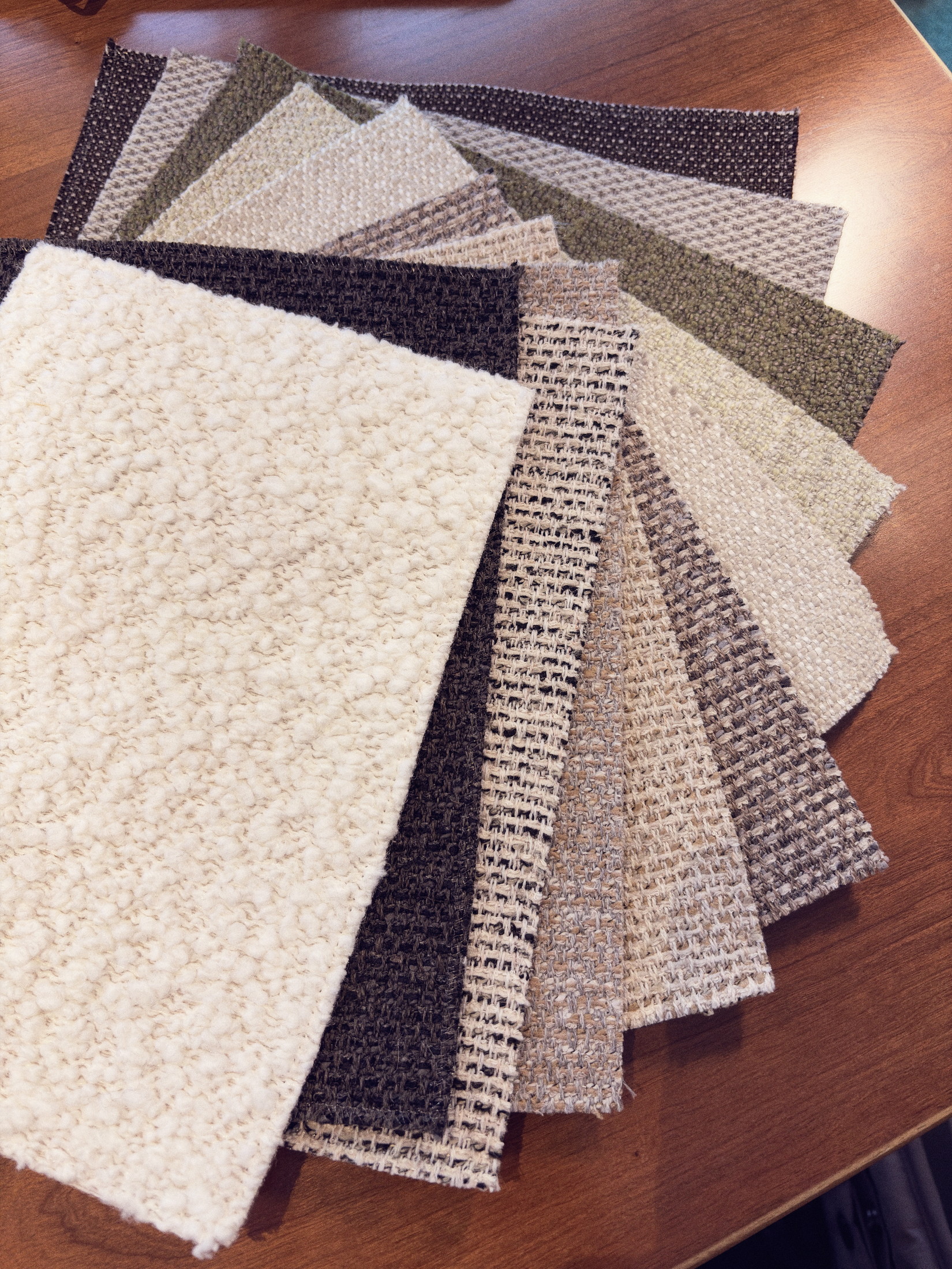 Kvadrat and Dedar upholstery swatches fanned out on a workbench