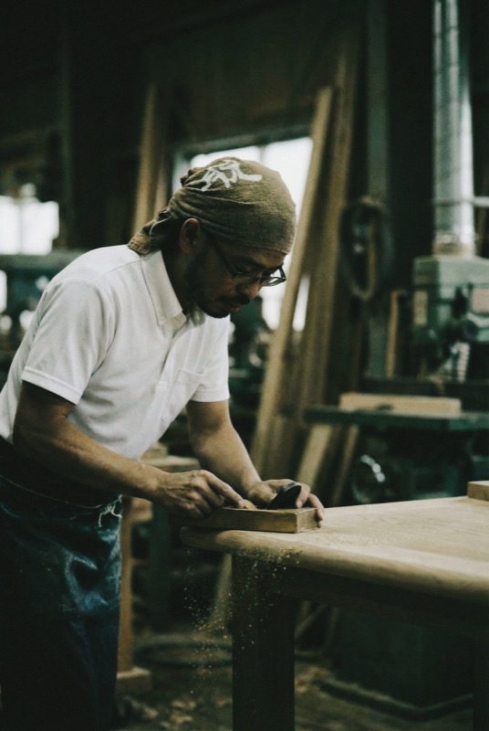 Craftsman hand-finishing ENWA furniture