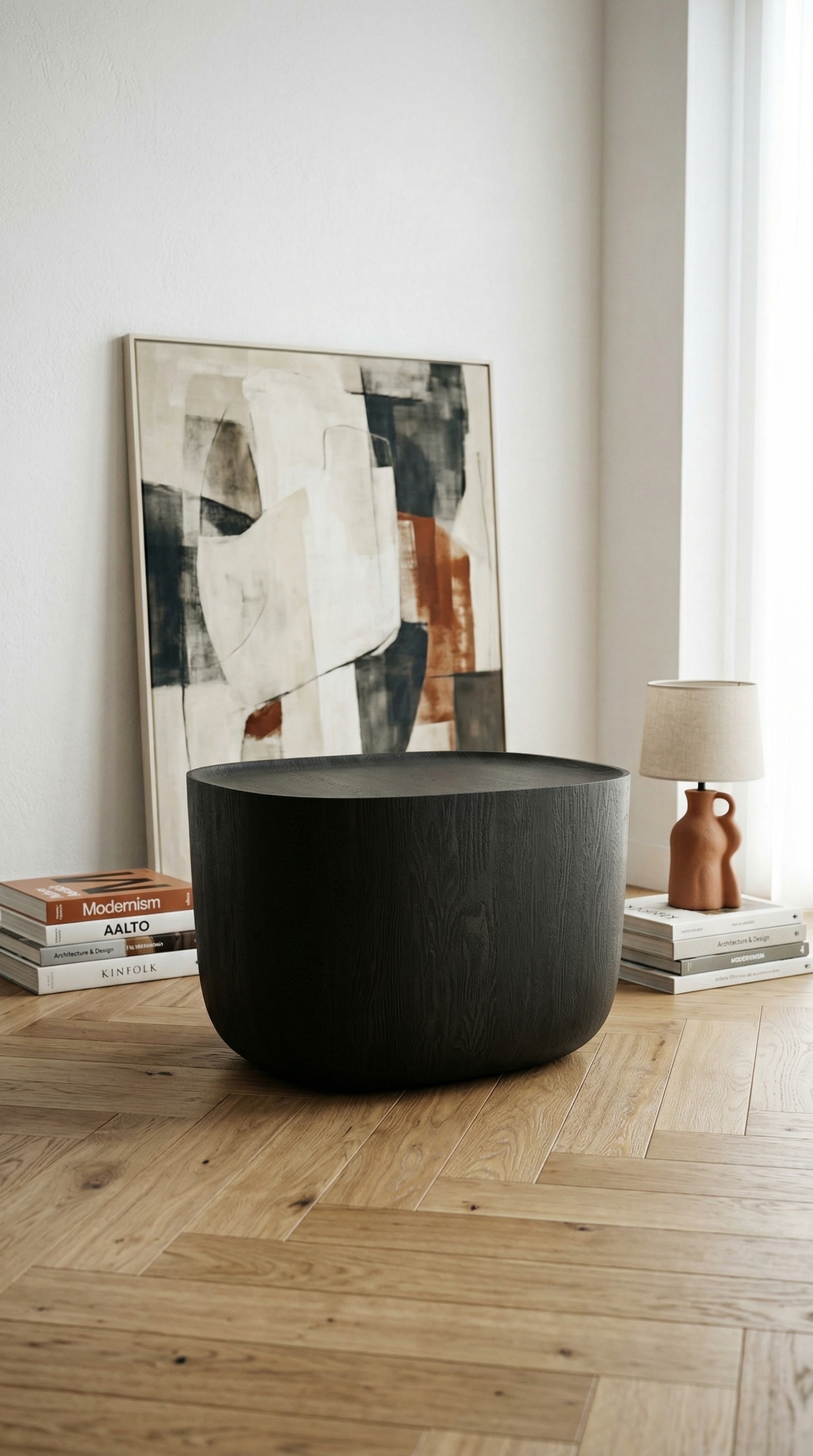 Ishi Stool as a side table beside art and books