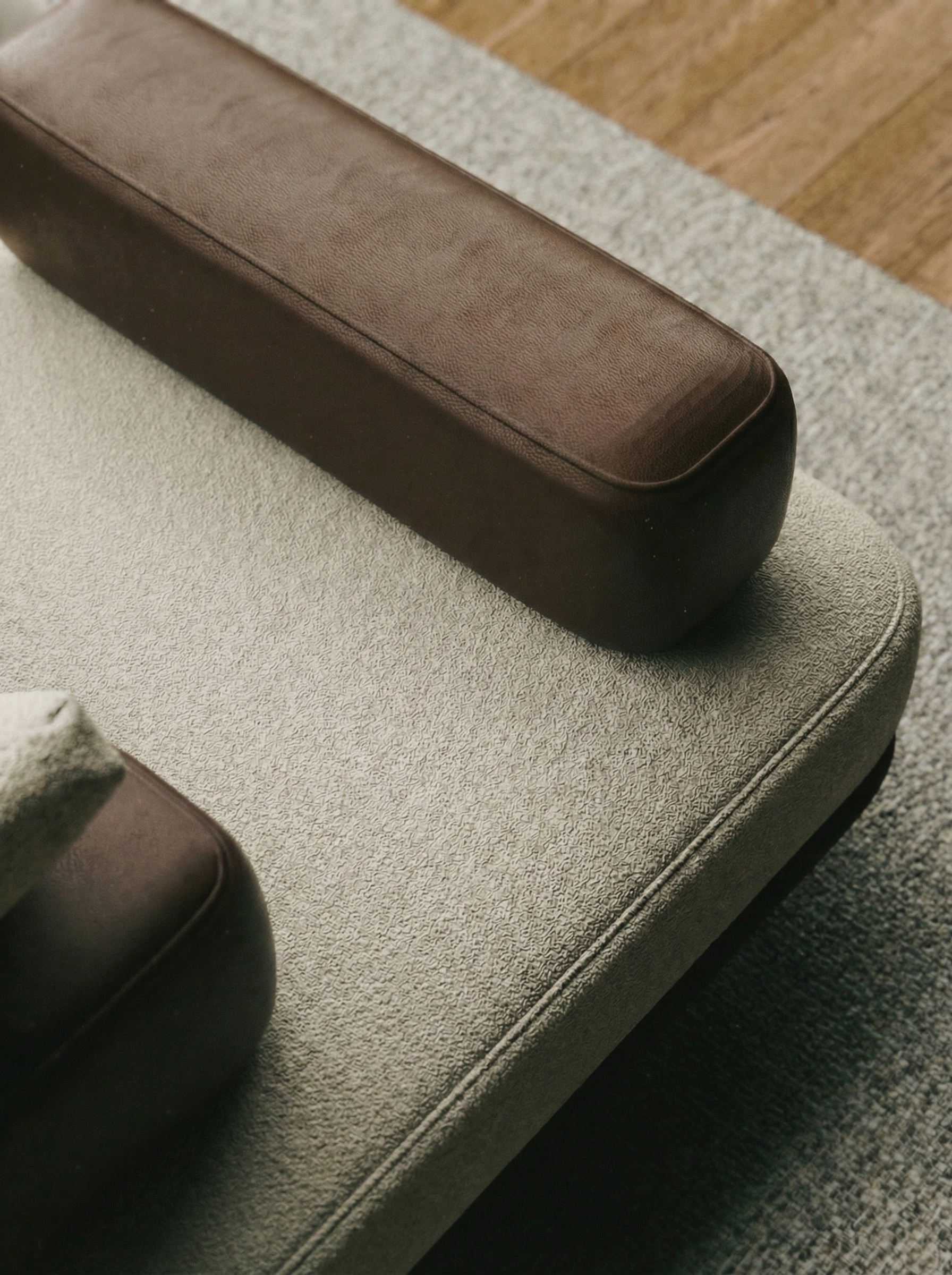 Sora Sofa close-up — bouclé wool fabric texture with leather bolster detail