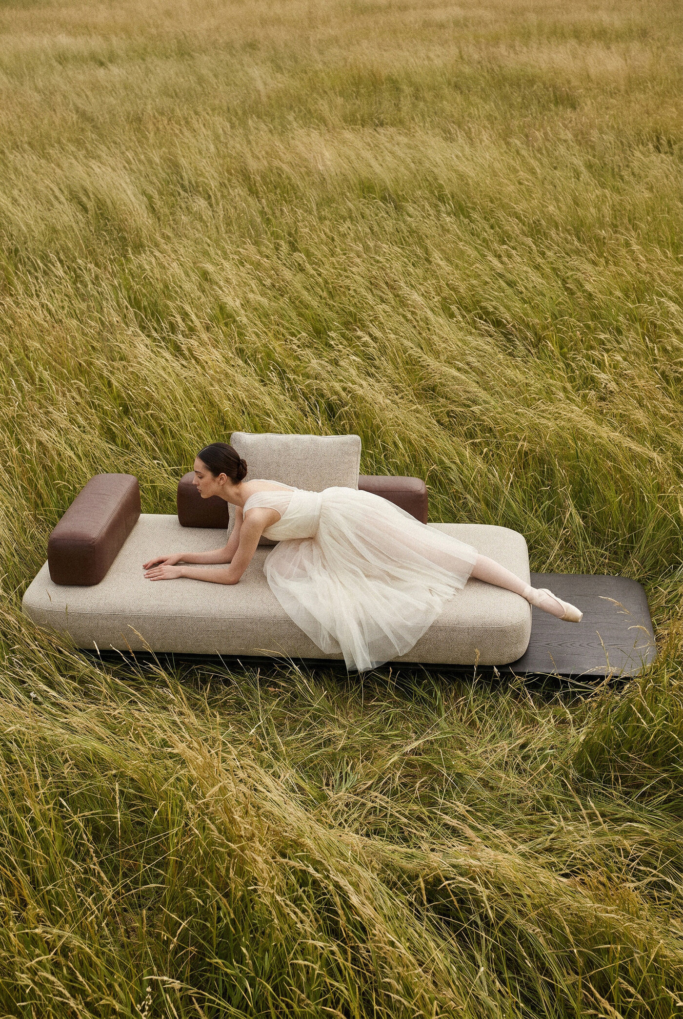 Sora Sofa in tall grass with dancer at rest