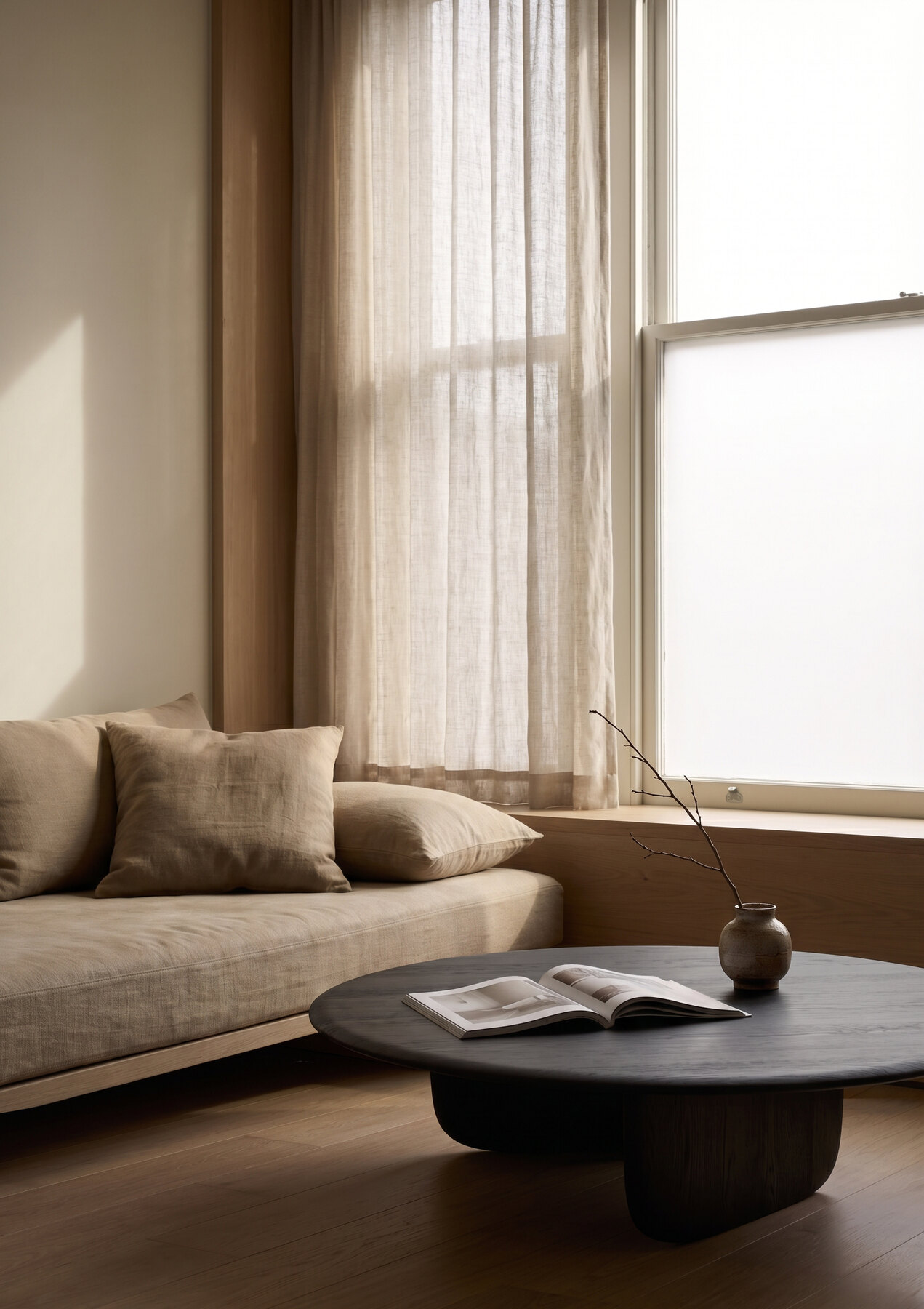 Tsuki Coffee Table in charcoal oak — sunlit bay window with sheer curtains