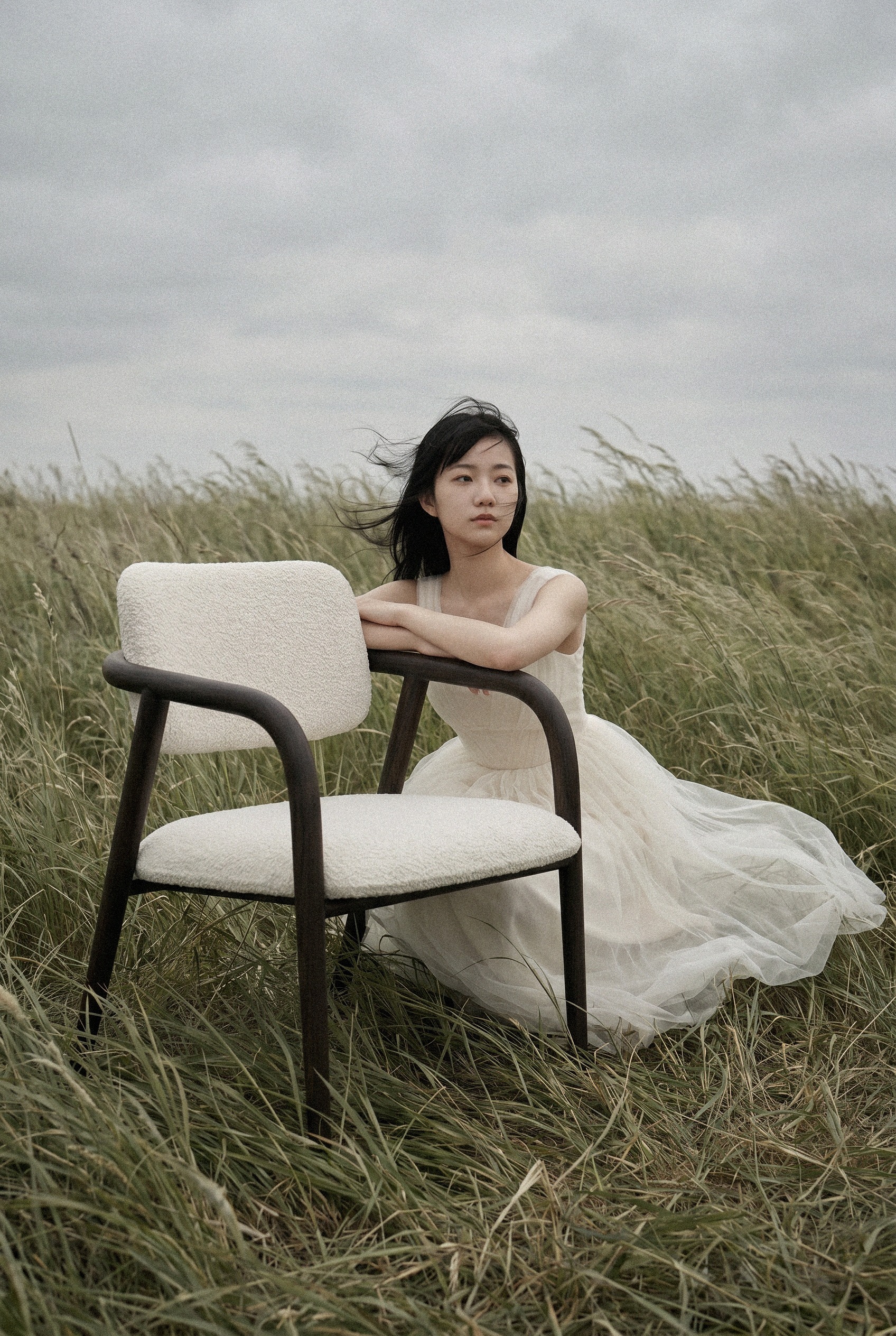 Yume Chair in a windswept meadow — editorial